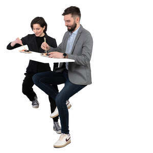 man and woman sitting in a restaurant and eating sushi