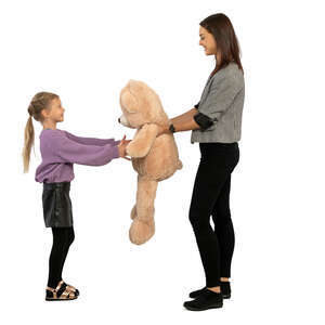 woman handing a little girl a big toy bear