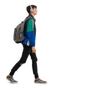 young man with headphones and backpack walking