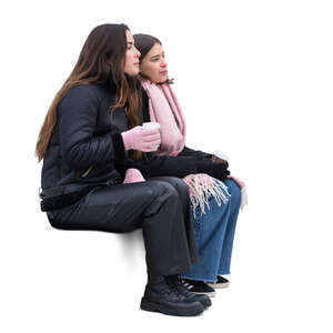 two women sitting outside in winter