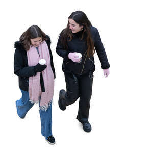 top view of two women with hot drinks walking in winter