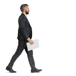 man in a suit and carrying a laptop walking