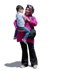 muslim woman standing and holding her son