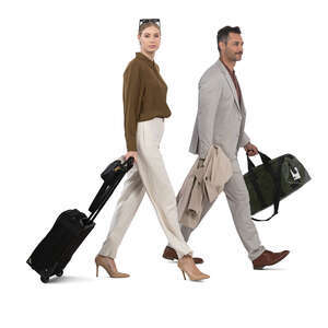 elegant man and woman with suitcases walking