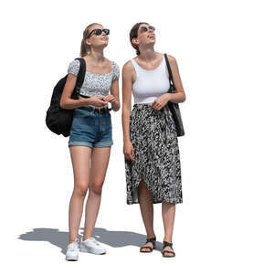 two young women standing and looking up