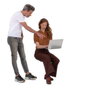 man standing and talking to a woman working with computer