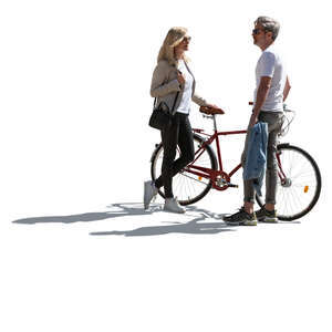 backlit man and woman with a bike standing