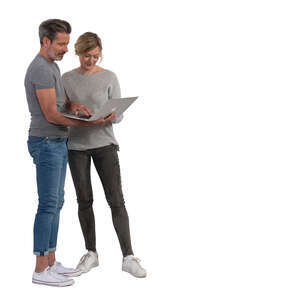 man and woman standing and looking at a computer together