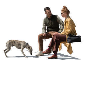 man and woman with a dog sitting and talking