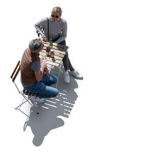 top view of a backlit couple sitting in a cafe