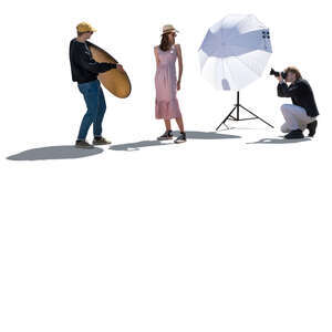 backlit scene of a photo shoot with a female model and photography team