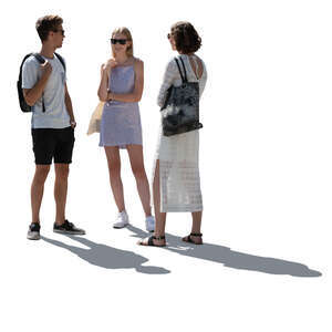 backlit group of three people standing