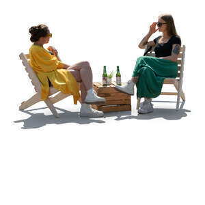 backlit image of two women sitting in a garden cafe