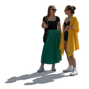 two backlit women standing and talking