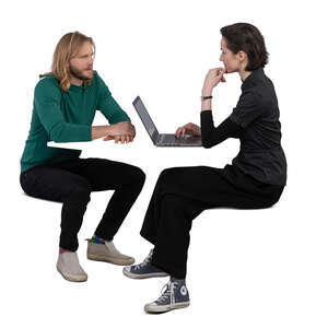 man and woman sitting by the table and working with computer