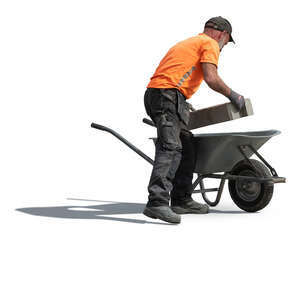 workman loading bricks into wheelbarrow