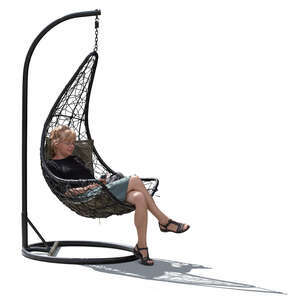 backlit woman sitting in a hanging chair