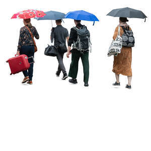 group of people with suitcases walking in the rain with umbrellas