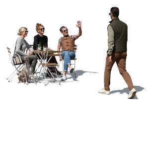 group of friends in a cafe greeting a man walking by