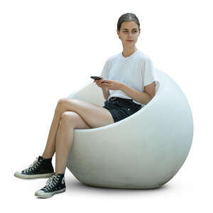 woman sitting in a ball shaped chair