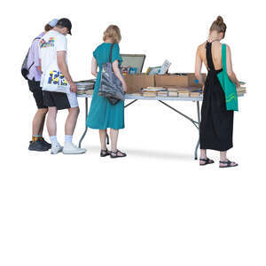 people standing by the book stand and looking at books