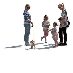 backlit group of women and children and a dog