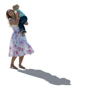 backlit woman lifting up her son