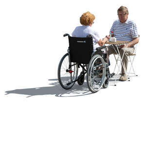 backlit couple with a woman in a wheelchair sitting in a cafe