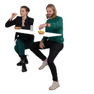 man and woman sitting and eating chips at a counter table