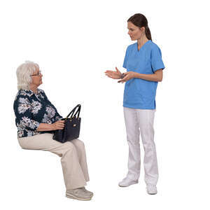 older lady sitting and listening to a medical worker