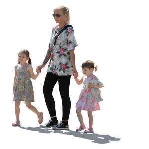 backlit woman with two girls walking hand in hand