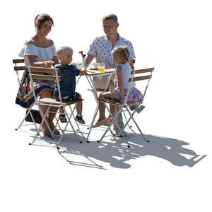 backlit family with small kids sitting in a cafe