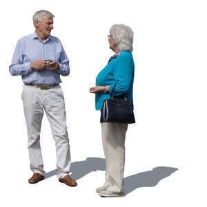 two grey haired people standing and talking