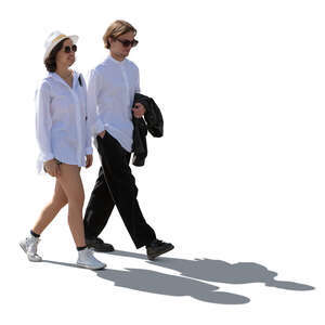 backlit man and woman in resort style clothing walking