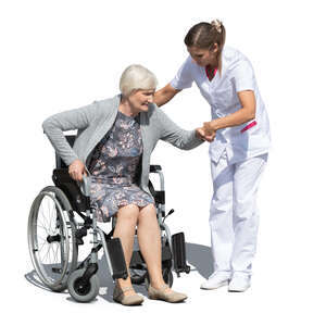 nurse helping an elderly woman sitting in a wheelchair to stand up
