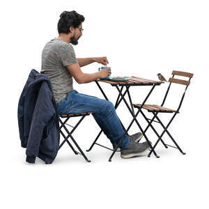 man sitting in a cafe and drinking coffee