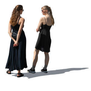 two women wearing black dresses standing