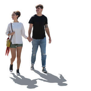 backlit latino couple walking hand in hand