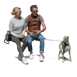 man and woman with a dog sitting and talking