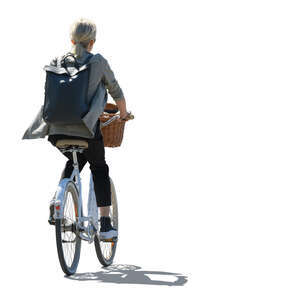 backlit woman with a backpack riding a city bike