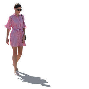 backlit woman in a striped summer dress walking