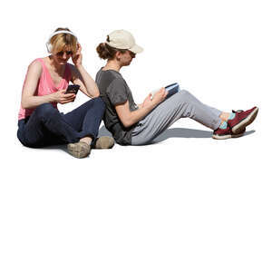 two people sitting on the ground and reading