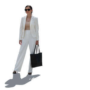 backlit woman in a white suit standing