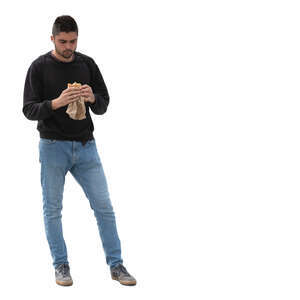 man standing and eating a sandwich