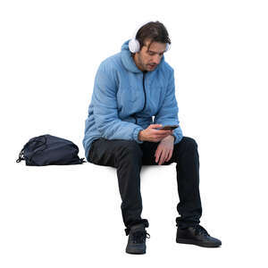 man in a blue jacket sitting