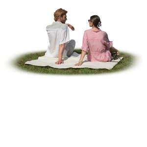 man and woman sitting on the grass