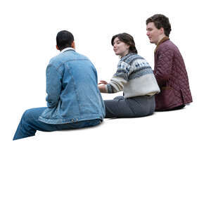 group of three young people sitting and talking