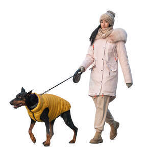 woman in winter walking her dog