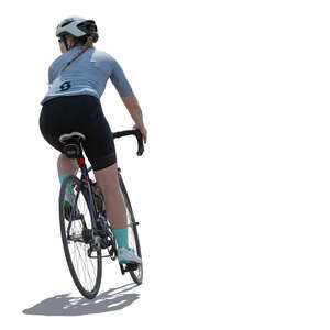 backlit female cyclist riding a bike