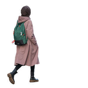 woman with a pink coat and green backpack walking